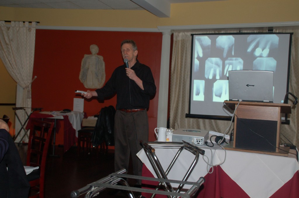 Dr. Fialkoff explaining several x-rays to people in his course